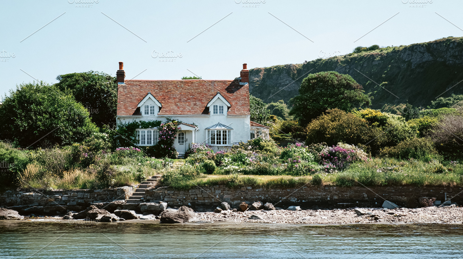 English seaside cottage on a rocky beach, surrounded by abundant, a Photo by Studio ANNA