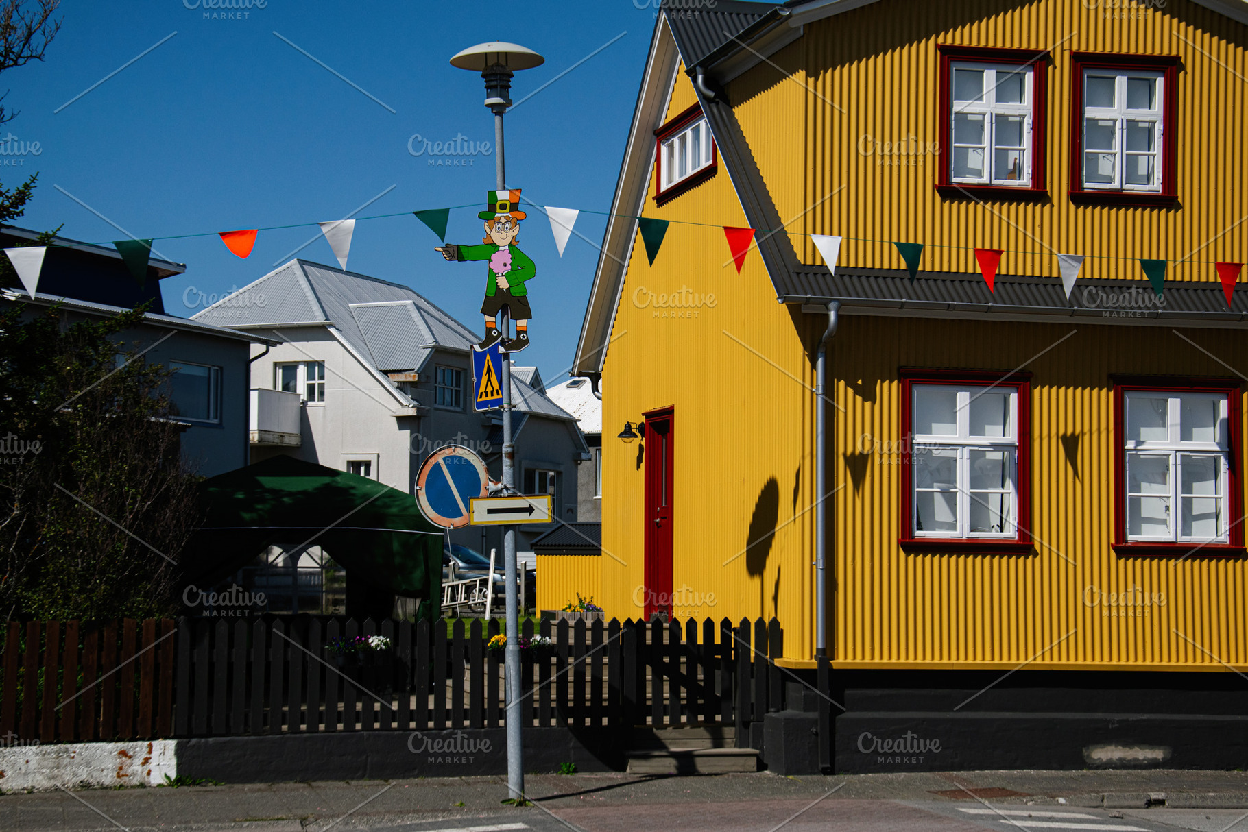 Colorful festive street scene in Akranes, Iceland with Irish celebration decor, a Photo by AS photostudio