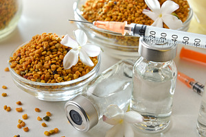 Detail of pollen allergy vaccines and jars filled elevated view, a Health & Medical Photo by Davizro's Market