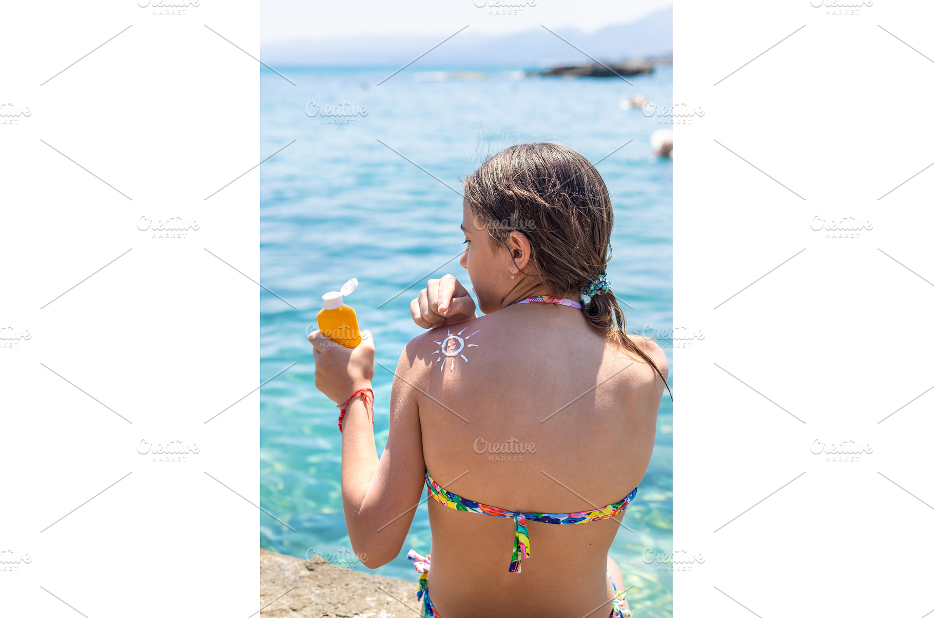 The child has sunscreen on his back, a Holiday Photo by yanadjana