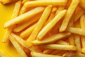 Delicious golden french fries on a bright yellow background ready for enjoyment, a Food & Drink Photo by AlyaAnd