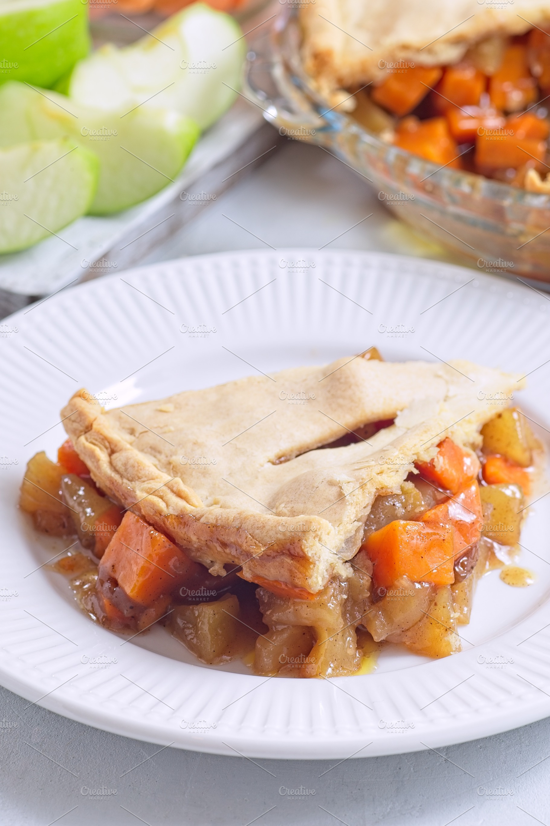 Delicious homemade apple and sweet potato cobbler pie showing filling ingredien, a Food & Drink Photo by iuliia_n
