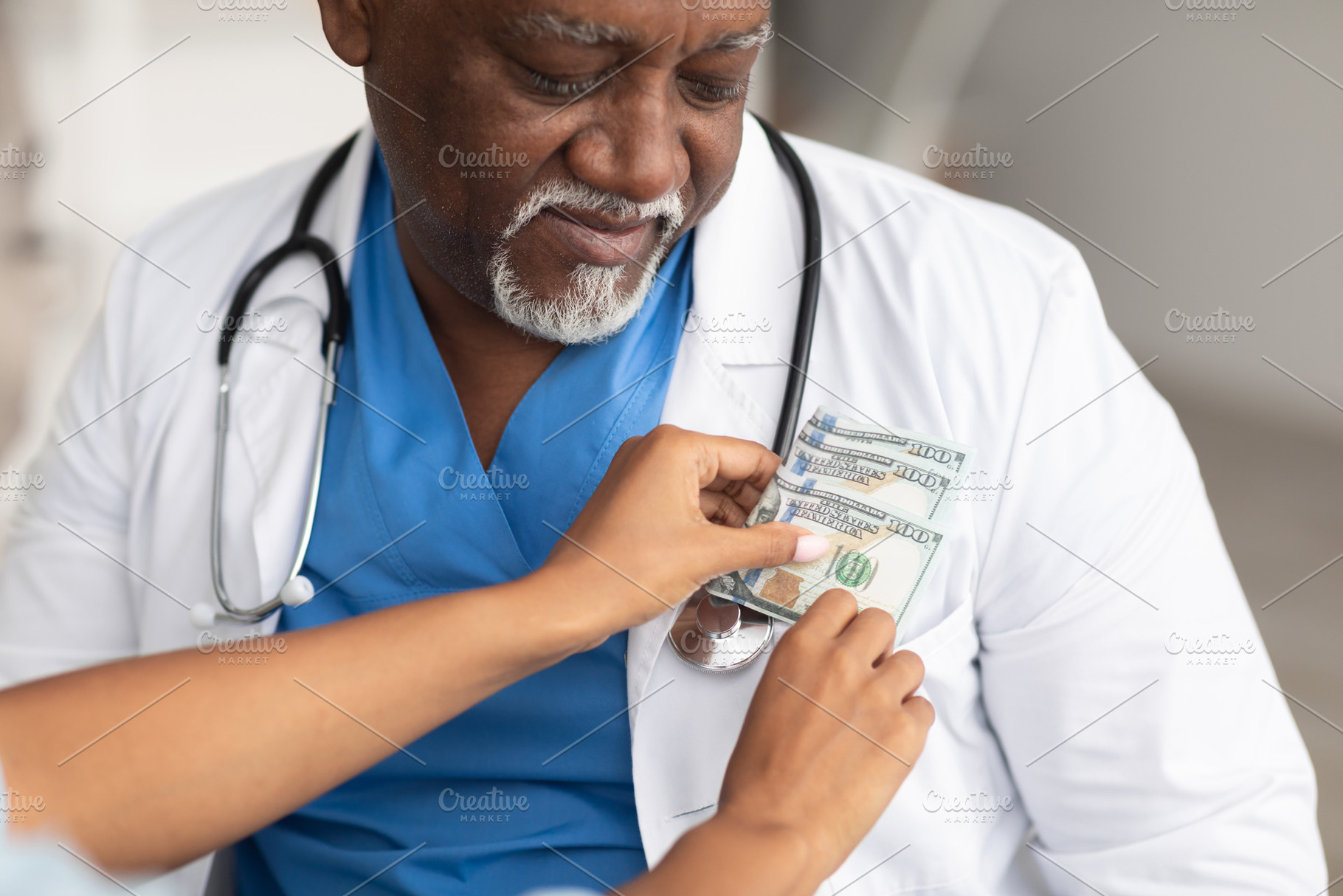 Black female hand putting money in doctor's pocket, a Photo by Prostock-Studio