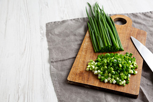 Organic Cut Green Onion Scallions on a Wooden Board, side view., a Food & Drink Photo by LiudmylaChuhunova