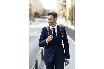 Handsome businessman walking in city, a Person Photo by nunezimage