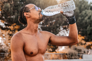 Athlete hydrating outdoors after tra, a Sports & Recreation Photo by Perpis