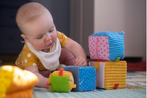 Caucasian baby toddler playing color