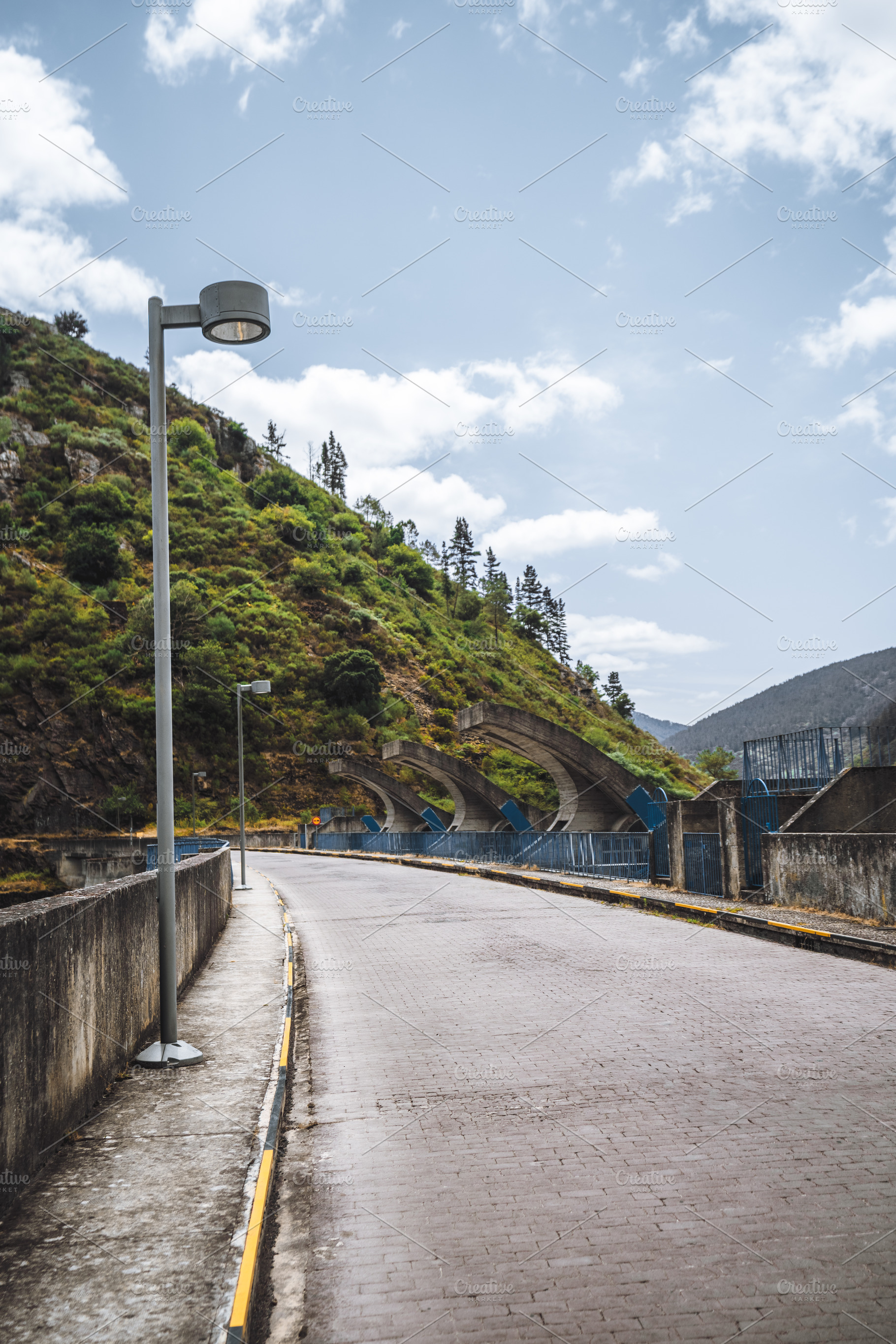 Dam top road with street lighting, an Industrial Photo by SkyNext