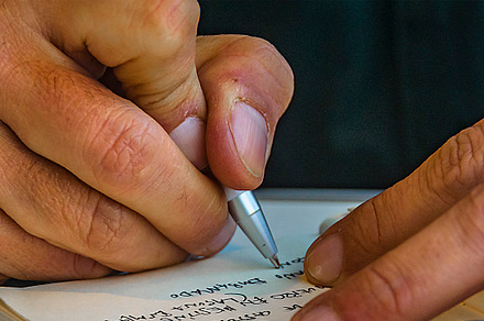 Man taking notes at notebook, an Arts & Entertainment Photo by DanFLCreativo