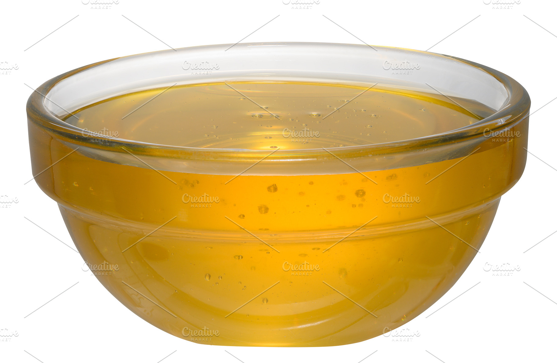 Golden honey in glass bowl on isolated background, a Food & Drink Photo by ndanko