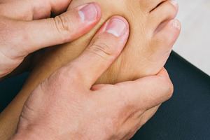 Physiotherapist massaging a foot