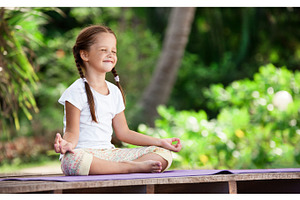 Child doing exercise on platform outdoors healthy lifestyle yoga girl