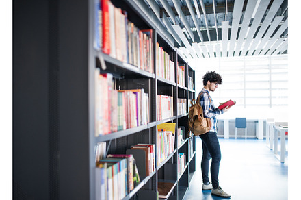 Male student in library, looking for, a School & Education Photo by HalfPoint