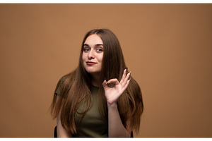 Young woman showing okay sign, a Person Photo by volodymyrshtun13795