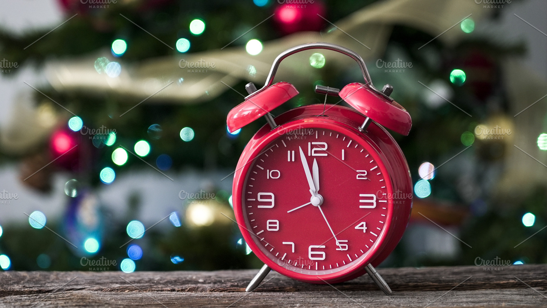Bright red alarm clock sits on woode, a Holiday Photo by 1miromiro
