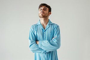 Young attractive boy in pajama on grey background, a Person Photo by AlyaAnd