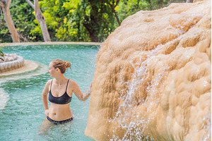 Female tourist exploring Grutas, a Holiday Photo by Elizaveta Galitskaya