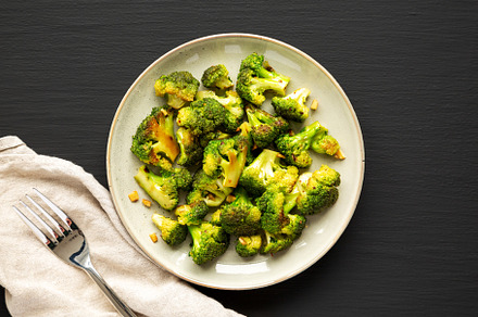 Homemade Pan-Fried Broccoli on a Plate on a black background, to, a Food & Drink Photo by LiudmylaChuhunova