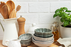Kitchen utensils and empty bowls resting on wooden countertop in, a Food & Drink Photo by Olena Rudo