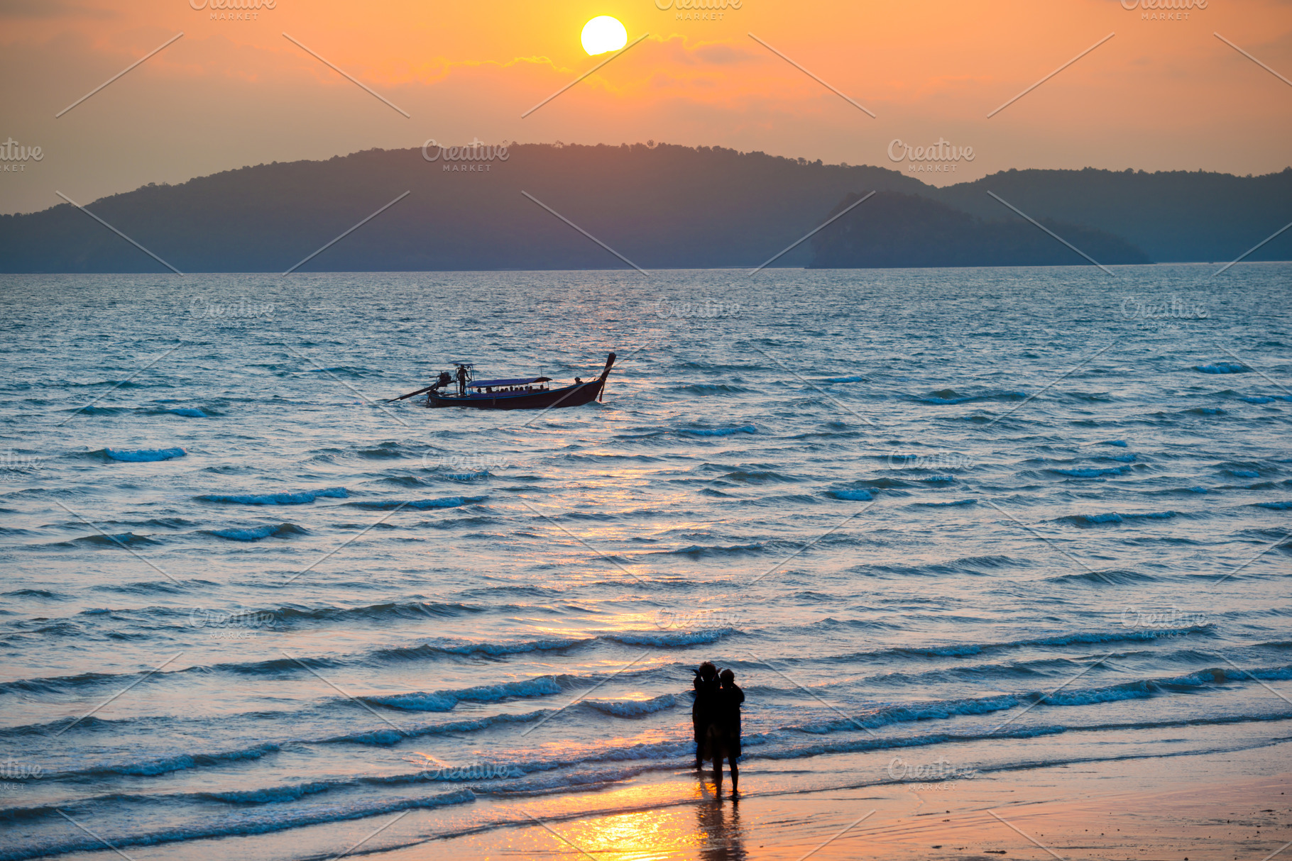 Silhouettes of people on beach at sunset, a Nature Photo by Vapi