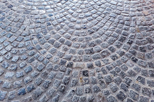 Circular cobblestone pavement with wet texture, a Background Photo by DanFLCreativo