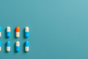 Pills on blue background illustratin, a Photo by Dvoevnore photos