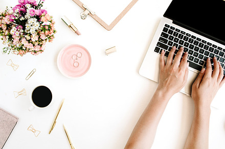 Girl working on laptop featuring wildflowers, laptop, and typing, a Business Photo by Floral Deco