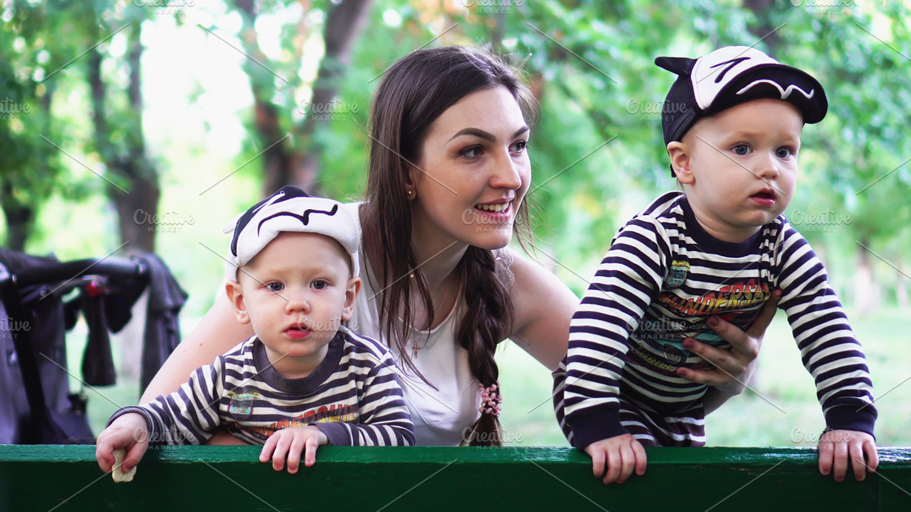 Mother with two sons in park, a Person Photo by logika 600