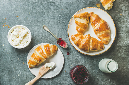 Freshly baked croissants with jam creamcheese and milk in bottle containing, a Food & Drink Photo by Foxys