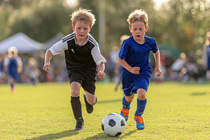 Young soccer players chase the ball, a Photo by Pixeness Studio