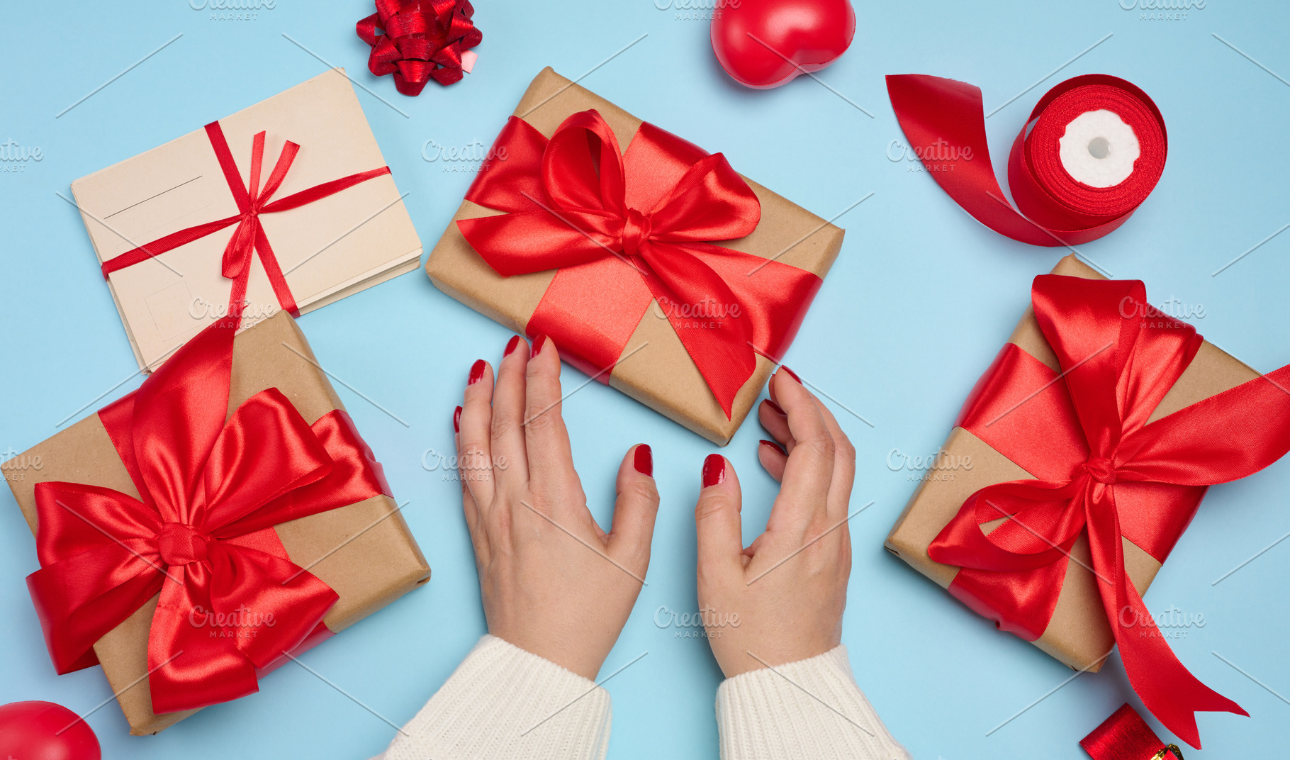 Preparing gifts for the holiday, gift boxes wrapped in red ribbo, a Holiday Photo by ndanko