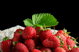 Ripe juicy strawberries with leaves on a linen napkin and wooden, a Food & Drink Photo by ndanko
