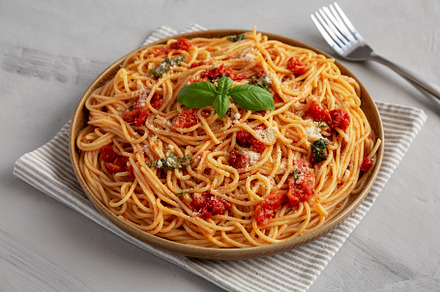 Homemade Spaghetti With Fresh Tomato Sauce on a Plate, side view, a Food & Drink Photo by LiudmylaChuhunova