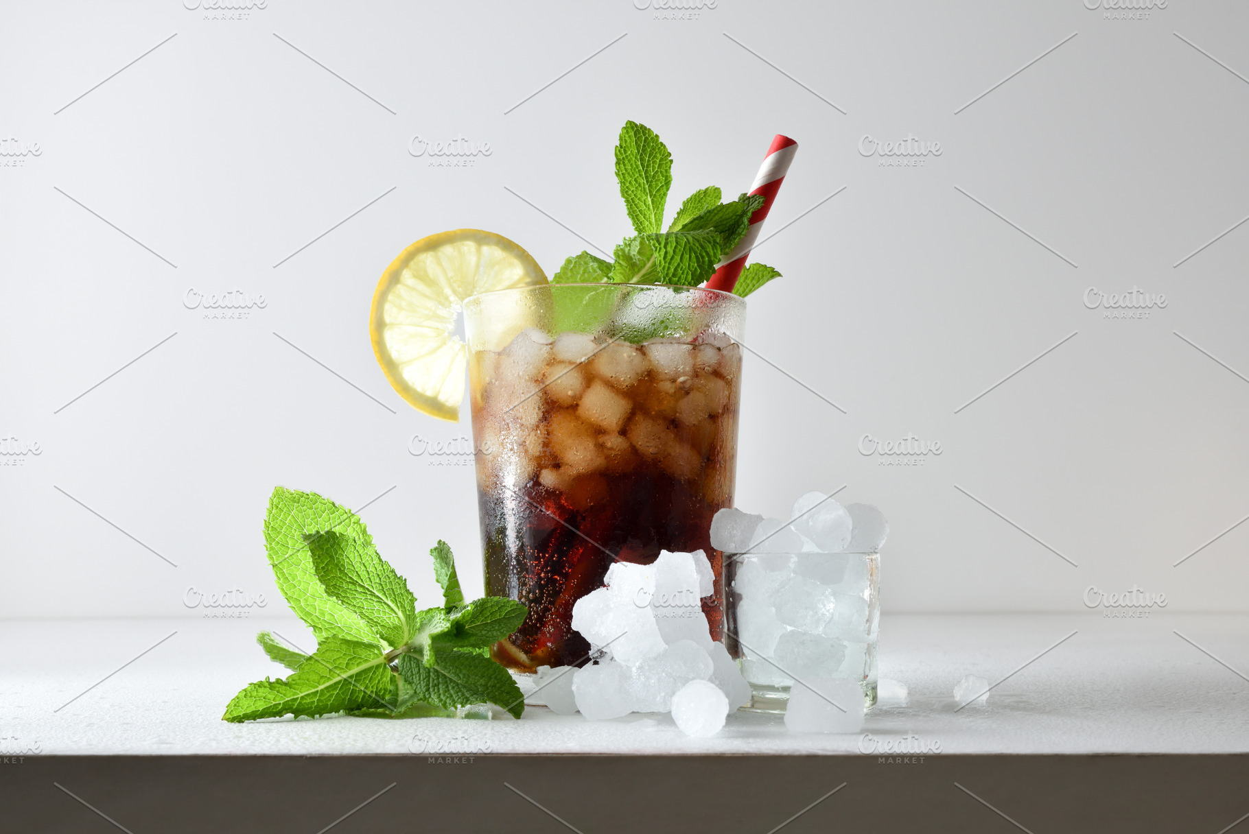 Refreshing cola drink with ice on a white isolated background, a Food & Drink Photo by Davizro's Market
