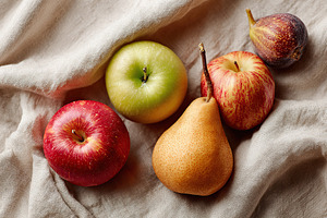 Freshly picked apples and pears arranged on a soft linen cloth for a still life, a Photo by AlyaAnd