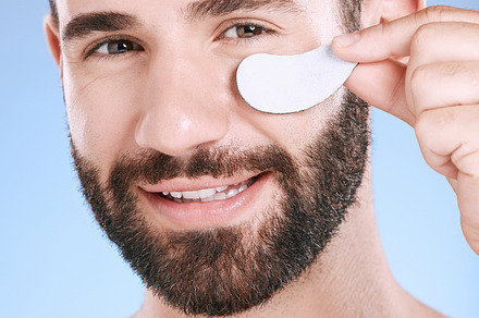 Beauty patch, eyes and portrait of man in studio for dermatology, skincare and glow. Male model, face and eye care product for body mask, healthy cosmetics and wellness of facial collagen treatment, a Photo by Peopleimages.com
