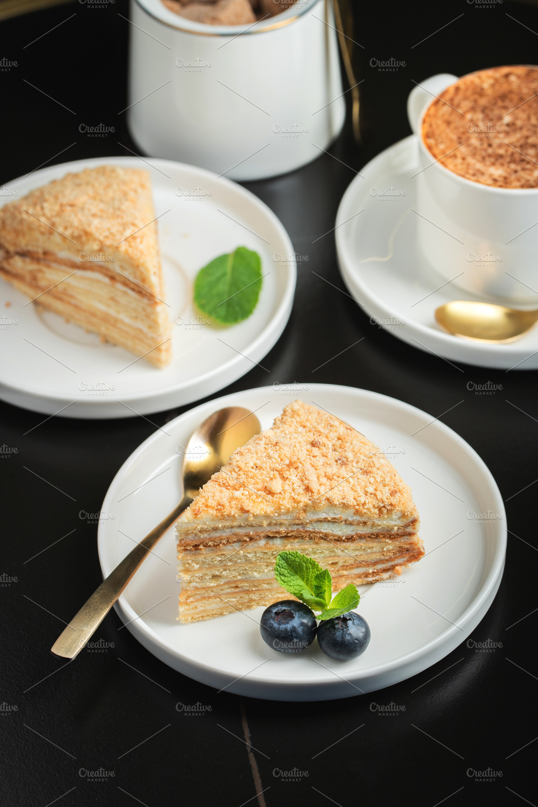 Medovik. Honey cake made from honey cakes with whipped sour cream, decorated wi, a Food & Drink Photo by Budarinphoto