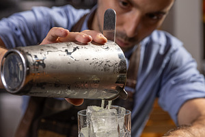 Bartender pouring ingredients, a Photo by Grafvision photography