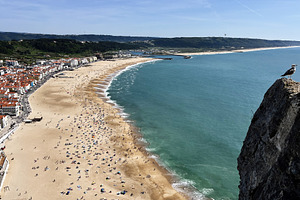 Scenic beach in Nazaré, Portugal with golden sands and ocean view, a Photo by AS photostudio