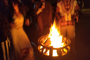 Night campfire gathering with warm storytelling atmosphere, a Person Photo by DanFLCreativo