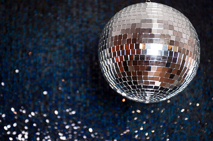 Mirror disco ball hanging from the ceiling containing disco, ball, and mirror
