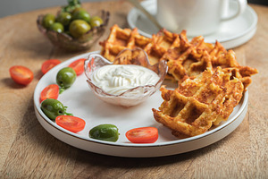 Top view of Homemade Potato Waffles, ricotta cheese and mayonese sauce. Served, a Food & Drink Photo by Budarinphoto