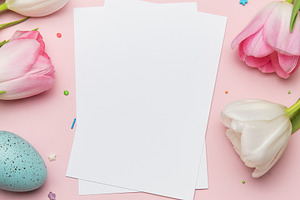 Easter greeting card mockup with colorful eggs and tulips on pin, a Photo by Olena Rudo