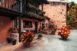 Rustic stone house with flowers, an Architecture Photo by SkyNext