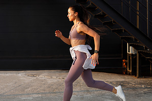 Side view of young female running, a Person Photo by Artem Varnitsin