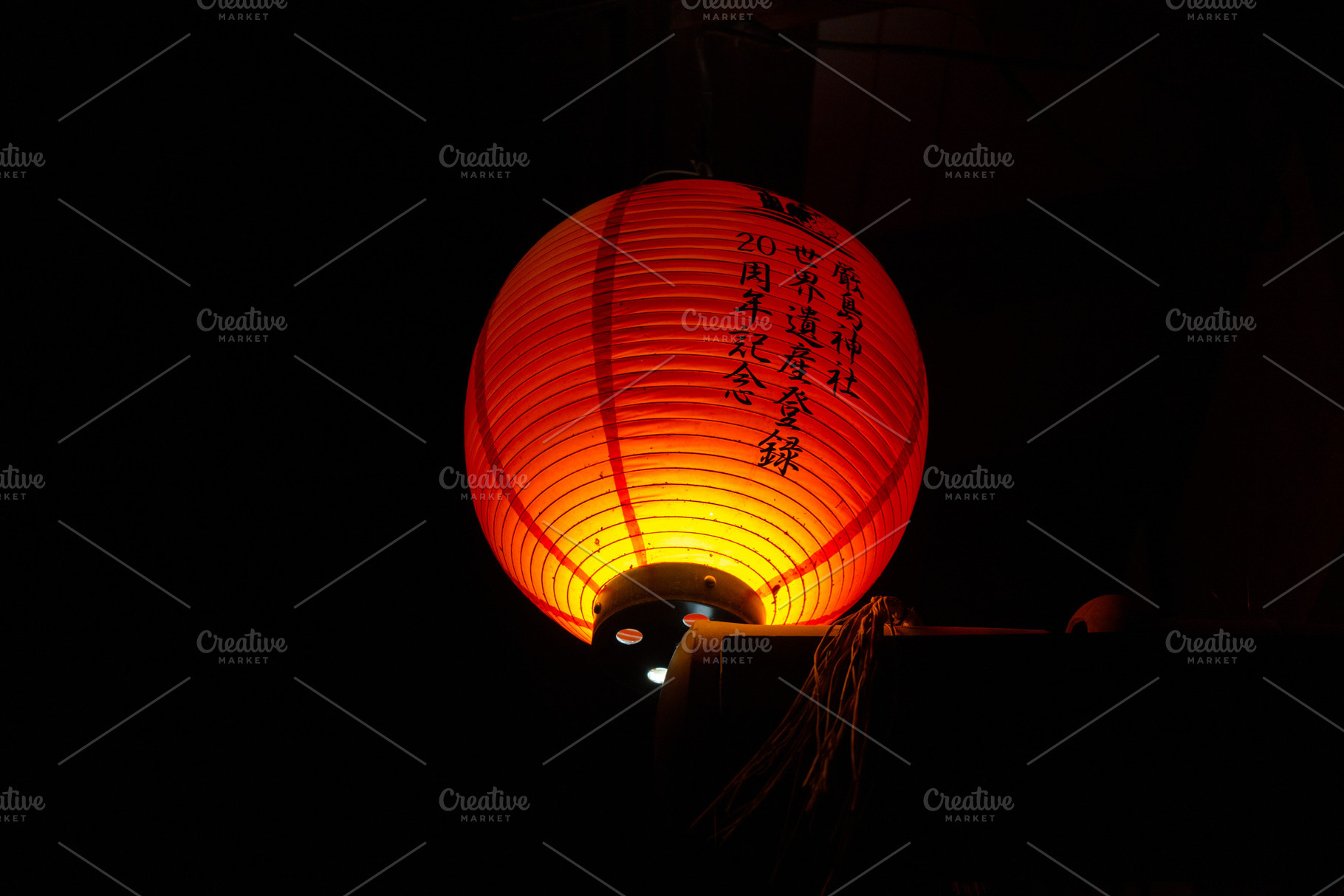 Traditional Japanese lantern glowing at night on Miyajima island, an Abstract Photo by GoodGoods