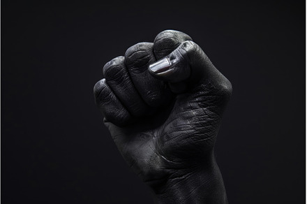 Black hand fist clenched. Generate, a Person Photo by Ylivdesign