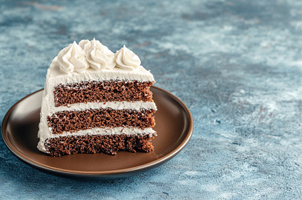 Delicious piece of cake with frosting cream, a Food & Drink Photo by AlyaAnd