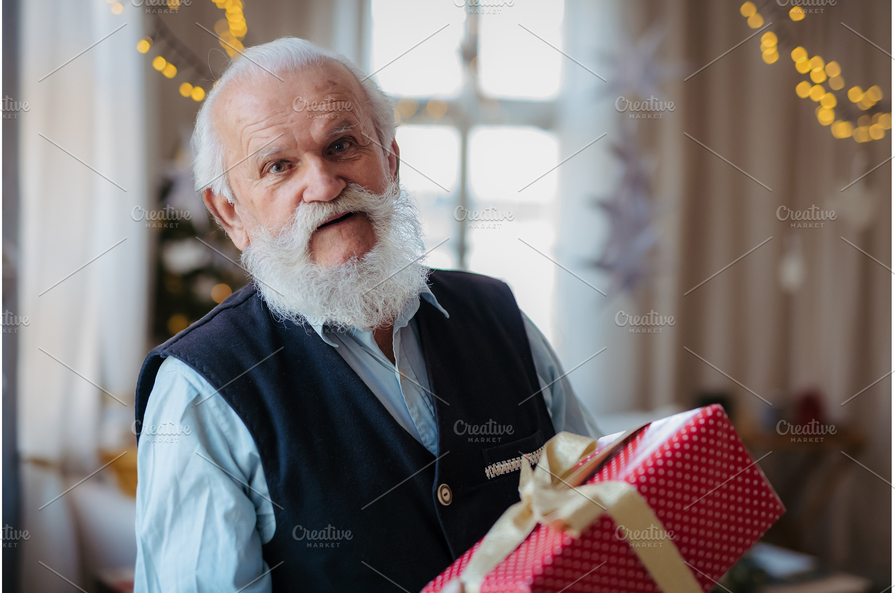 Senior man holding Christmas gift., a Person Photo by HalfPoint