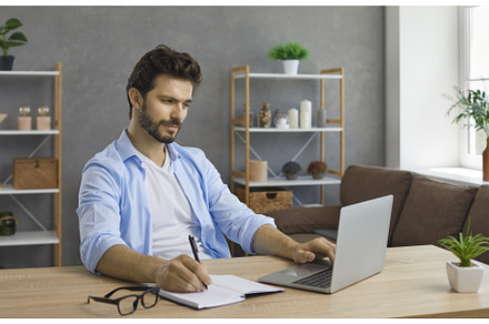 Young man sitting at desk with, a School & Education Photo by StudioRomantic
